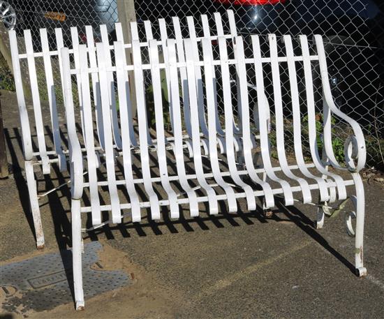 A pair of white painted wrought iron garden benches, W.114cm